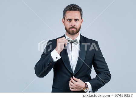 confident and successful businessman in tuxedo bow tie on formal event, sommelier confident and successful businessman in tuxedo bow tie on formal event, sommelier 97439327