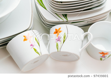 cups and plates with the image of flowers on a white table cups and plates with the image of flowers on a white table 97439801