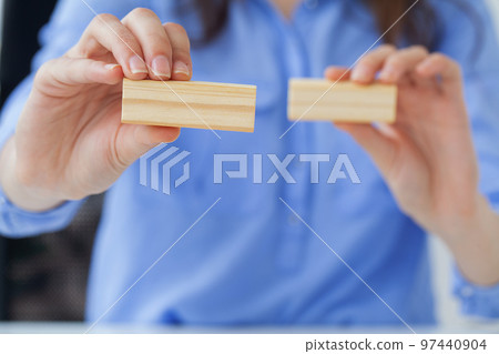 Woman hand of engineer playing a wood block Woman hand of engineer playing a wood block 97440904