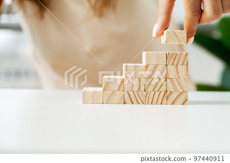 Woman hand of engineer playing a wood block Woman hand of engineer playing a wood block 97440911