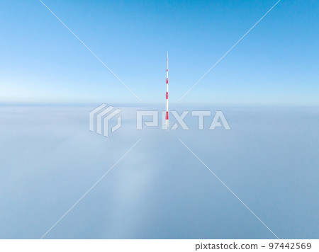 Aerial drone top view of the Riga TV Tower in Latvia. Highest TV tower in Europe over the clouds. Aerial drone top view of the Riga TV Tower in Latvia. Highest TV tower in Europe over the clouds. 97442569