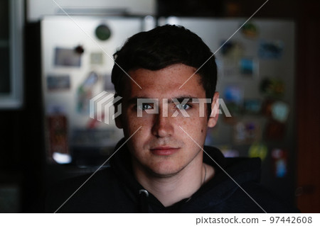 Defocus portrait young man indoors background. Serious young man with blue eyes. 20s years. Handsome man outdoors portrait. Student. Closeup. Out of focus 97442608