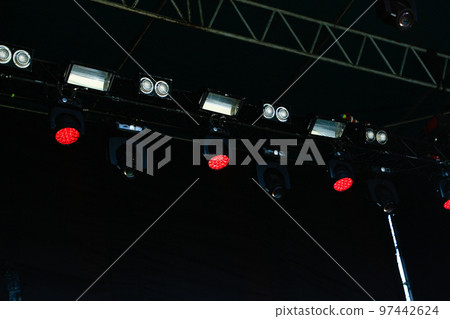 Defocus many red spotlights that illuminate the stage at a concert with fog. spotlights on a theatre stage on black background. Out of focus Defocus many red spotlights that illuminate the stage at a concert with fog. spotlights on a theatre stage on black background. Out of focus 97442624