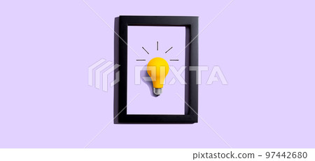Yellow light bulb inside a frame - inspiration, creativity themes 97442680