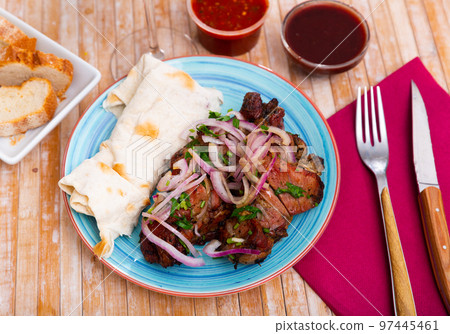 Grilled pork meat shashlik with sliced onion Grilled pork meat shashlik with sliced onion 97445461