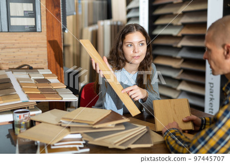 Seller working with client offering laminate flooring Seller working with client offering laminate flooring 97445707