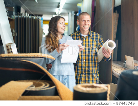 Woman and man discussing shopping list in building store Woman and man discussing shopping list in building store 97445749