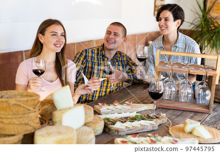 Cheerful people tasting artisanal goat cheese at Spanish farm Cheerful people tasting artisanal goat cheese at Spanish farm 97445795