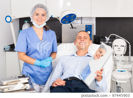 Smiling female cosmetologist and satisfied client after cosmetology procedures Smiling female cosmetologist and satisfied client after cosmetology procedures 97445903