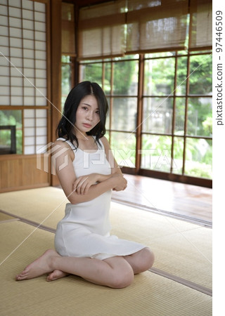 A beautiful young woman wearing a dress in a Japanese-style room in an old private house A beautiful young woman wearing a dress in a Japanese-style room in an old private house 97446509