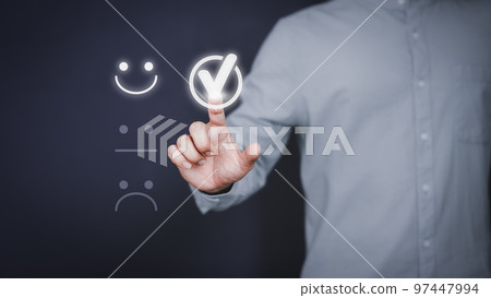 Man touching the virtual screen on the happy smiley face icon to give satisfaction in service. Rating very impressed. Customer service, testimonial and satisfaction concept. Man touching the virtual screen on the happy smiley face icon to give satisfaction in service. Rating very impressed. Customer service, testimonial and satisfaction concept. 97447994