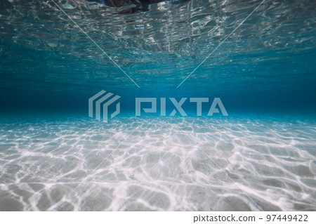 Blue ocean with white sand and sunlight underwater. Transparent ocean background 97449422
