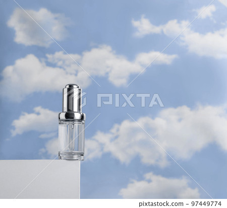 Transparent serum on white podium against cloudy blue sky. Concept of lightness of cosmetics Transparent serum on white podium against cloudy blue sky. Concept of lightness of cosmetics 97449774