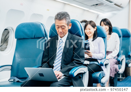 Middle-aged businessman going on a business trip by plane 97450147