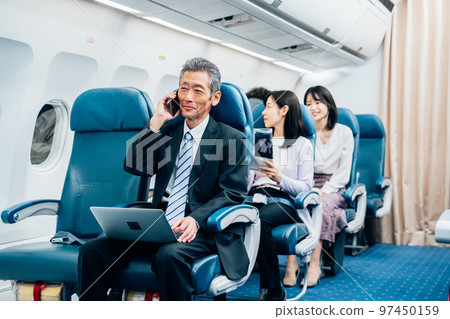 Middle-aged businessman going on a business trip by plane Middle-aged businessman going on a business trip by plane 97450159
