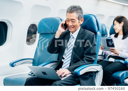 Middle-aged businessman going on a business trip by plane Middle-aged businessman going on a business trip by plane 97450160
