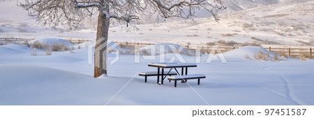picnic table covered by fresh snow at Colorado foothills 97451587