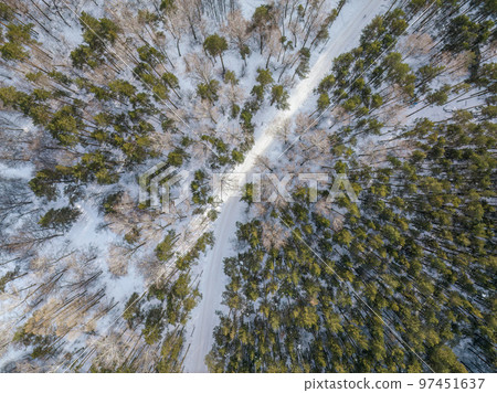 Flight over the winter mountains with road serpentine and pine forest. Top down view. Landscape photography Flight over the winter mountains with road serpentine and pine forest. Top down view. Landscape photography 97451637