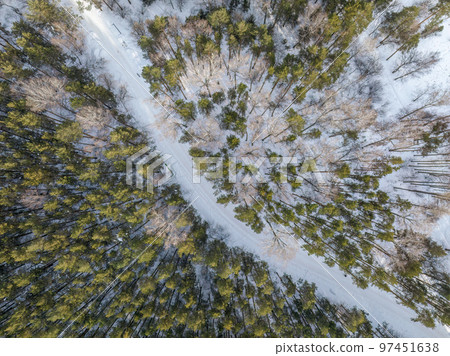 Flight over the winter mountains with road serpentine and pine forest. Top down view. Landscape photography Flight over the winter mountains with road serpentine and pine forest. Top down view. Landscape photography 97451638