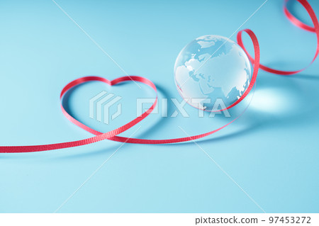 Glass globe and ribbon blue background 97453272