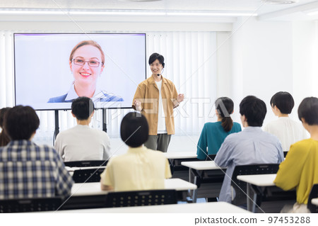 College student listening to a foreigner connected online 97453288