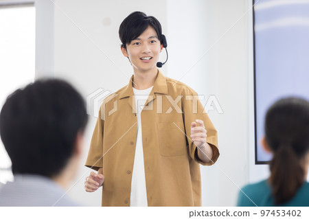 Seminar A man speaking with a head microphone Seminar A man speaking with a head microphone 97453402