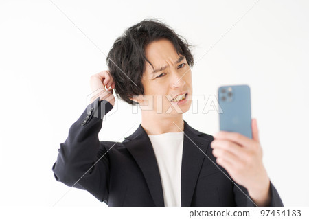 Men in their 20s looking at a smartphone 97454183