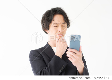 Men in their 20s looking at a smartphone 97454187