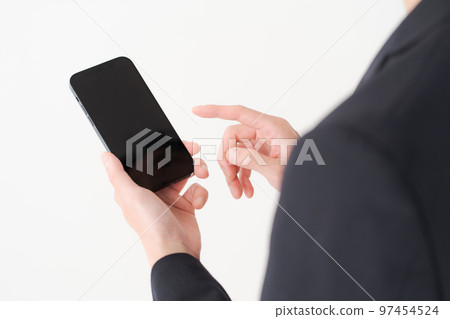 Men in their 20s looking at a smartphone 97454524