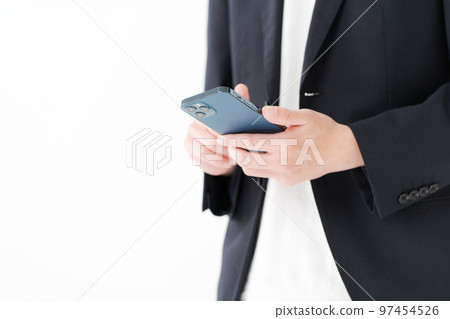 Men in their 20s looking at a smartphone Men in their 20s looking at a smartphone 97454526