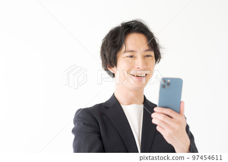 Men in their 20s looking at a smartphone 97454611