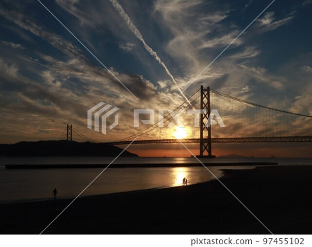 Sunset over the Akashi Kaikyo Bridge with beautiful autumn clouds seen in the Seto Inland Sea 97455102