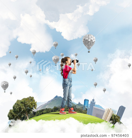 Concept of careless happy childhood with girl looking in future Concept of careless happy childhood with girl looking in future 97456403