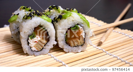 Traditional Japanese food. Sushi rolls on the bamboo mat 97456414