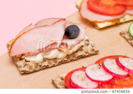 Whole Grain Crispbread with Ham, Tomato, Radish, Cucumber and Cheese 97456656