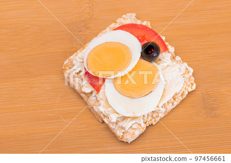 Rice Cake Sandwich with Tomato, Eggs and Olives 97456661