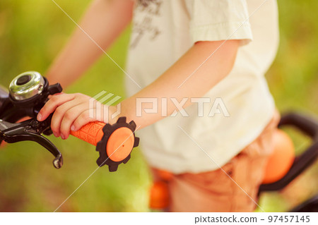Boy with a bicycle on the street 97457145