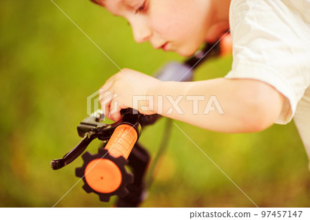 Boy with a bicycle on the street 97457147
