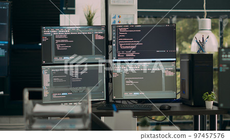 Empty office desk with multiple screens running software developing script on terminal window, it agency computers showing code database algorithms, network servers innovation. 97457576