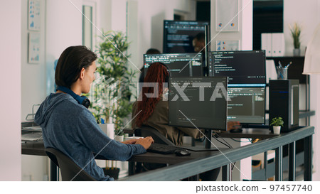 Asian software programer writing code on computer, displaying artificial intelligence algorithm. App developer coding database program, doing cloud computing with it server. Tripod shot. Asian software programer writing code on computer, displaying artificial intelligence algorithm. App developer coding database program, doing cloud computing with it server. Tripod shot. 97457740