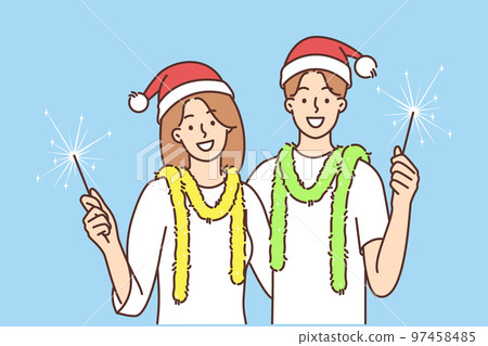 Smiling couple with sparklers celebrate New Year Smiling couple with sparklers celebrate New Year 97458485