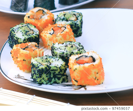 sushi rolls and chopsticks on a wooden table sushi rolls and chopsticks on a wooden table 97459037