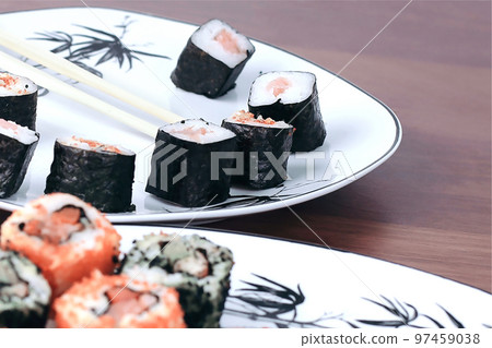 sushi rolls and chopsticks on a wooden table sushi rolls and chopsticks on a wooden table 97459038