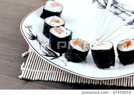 close-up of sushi and chopsticks on a white plate close-up of sushi and chopsticks on a white plate 97459059