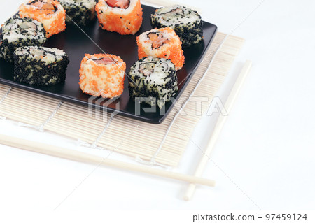 different types of Maki sushi on a black plate different types of Maki sushi on a black plate 97459124