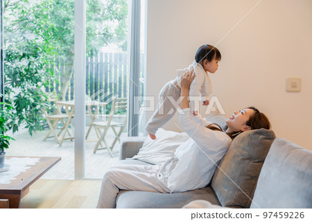 Mother doing high high to baby at home 97459226