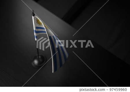 Small national flag of the Uruguay on a black background 97459960