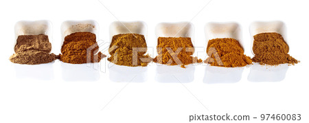 Small  ceramic bowls of Indian spices isolated on white  background. 97460083