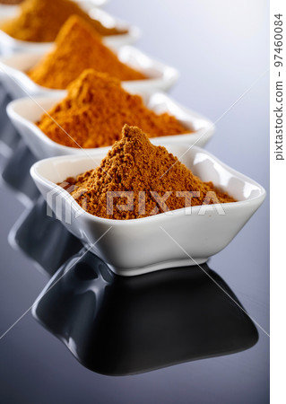 Ceramic bowls of Indian spices on black reflective background. Ceramic bowls of Indian spices on black reflective background. 97460084
