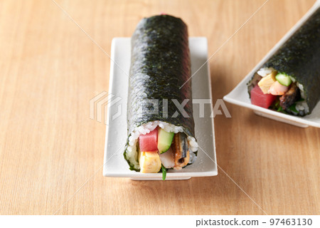 Eho-maki served on a plate (Ingredients: tuna, boiled conger eel, cucumber, omelet, perilla, shrimp.) Eho-maki served on a plate (Ingredients: tuna, boiled conger eel, cucumber, omelet, perilla, shrimp.) 97463130